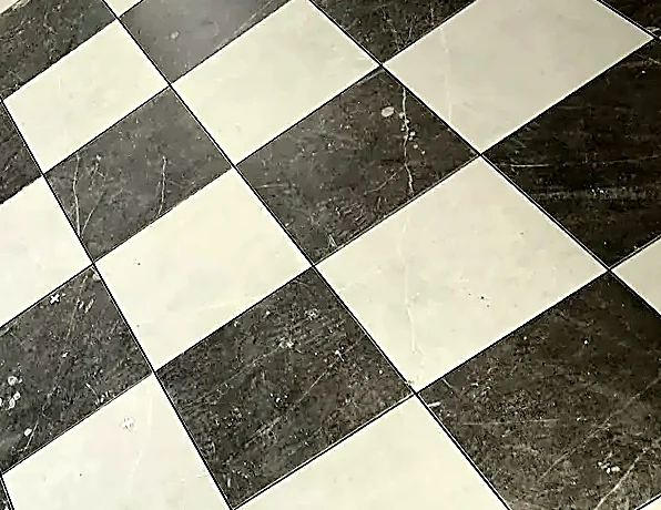 Where the diagonal checker meets the wall — every cut the same size down the run