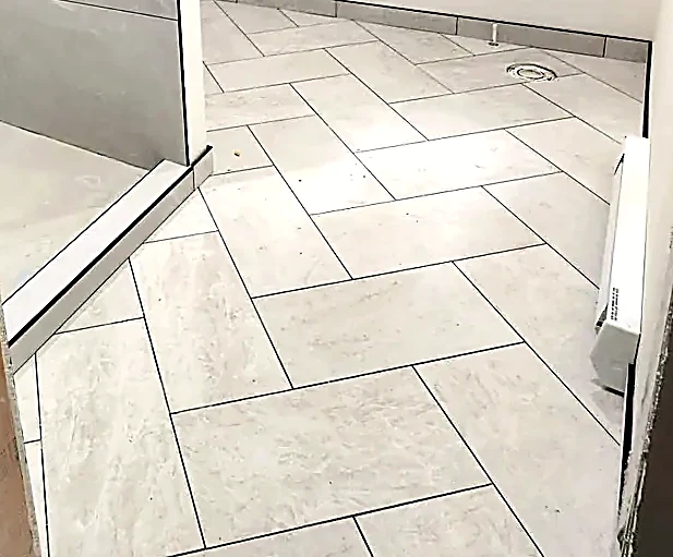 Stone-look herringbone, cut to the room rather than the wall