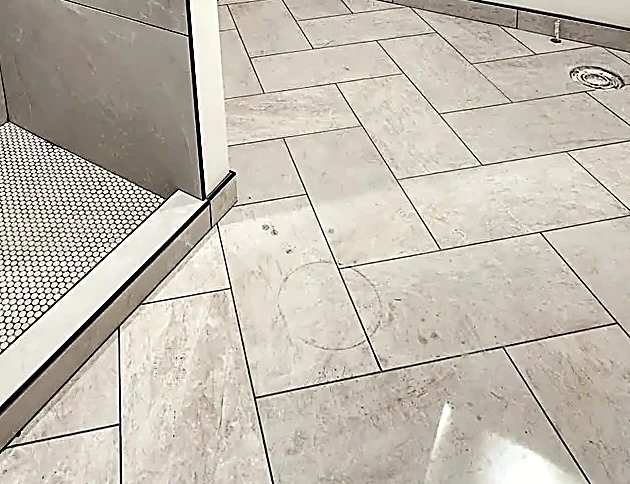 Herringbone bathroom floor running to a shower threshold