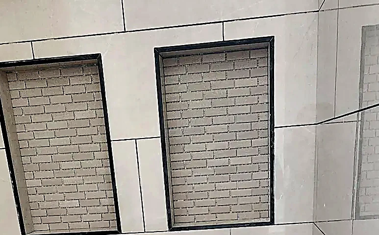 Two recessed shower niches set level and square to the wall tile
